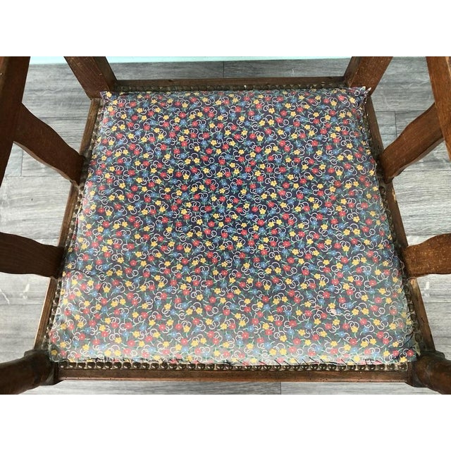 Ancient beech wood chair with carved armrests End of the 19th century The session is in fabric fixed with studs