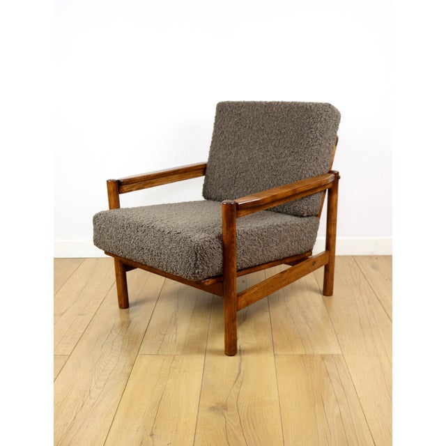 Vintage wooden armchair designed by Z. Baczyk in chocolate brown boucle lamb fabric. A classic piece with a timeless...