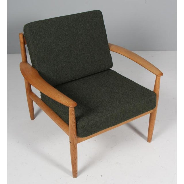 Grete Jalk lounge chair in oak. New upholstered cushions with green boucle fabric from Nevotex. Made by France &...
