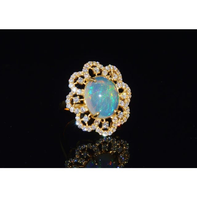 Stunning 18K solid gold 6.29CTS natural diamond and untreated opal floral ring. The ring features a large 5.03CTS natural...