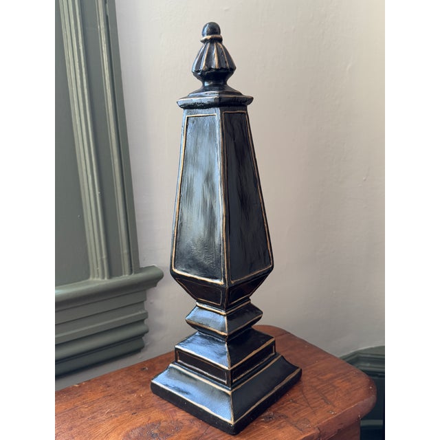 Classic obelisk in black and gold paint. 16.5" tall 5.25" square base