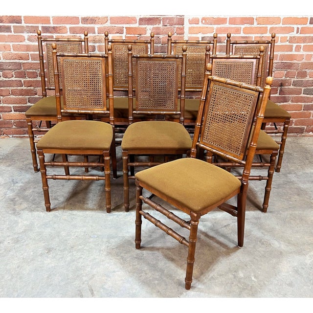 A rare and stylish set of 8 mid-century folding chairs by Stakmore, featuring a classic faux bamboo frame with woven cane...