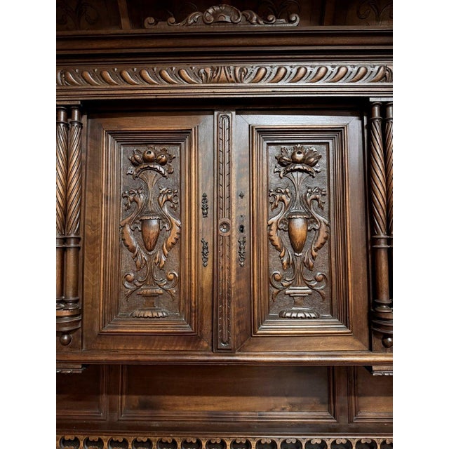 Important Renaissance-style walnut buffet Front opening with five carved doors and three drawers Vaulted upper section...