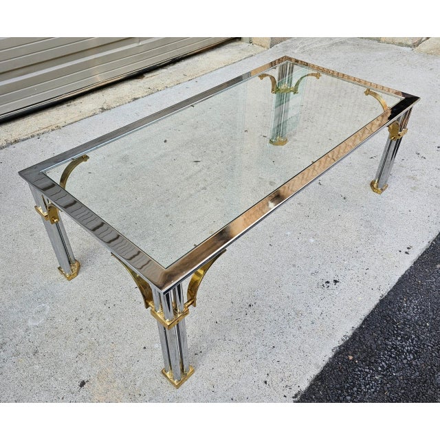 Amplify the feeling of space and light within your living space with this Maison Jansen-style brass, Chrome, and Glass...