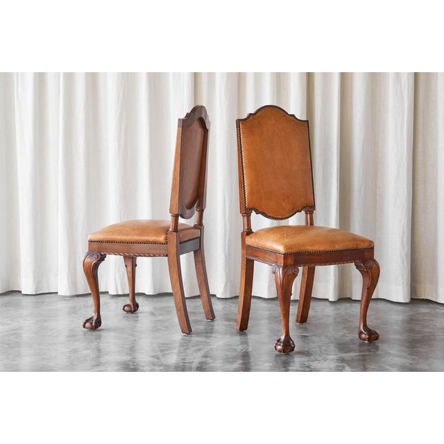 This is a very rare pair of 't Woonhuys Amsterdam side chairs in very desirable patinated cognac leather, made in the...