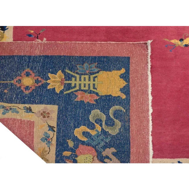 A beautiful early 20th century Chinese Art deco rug with a cranberry field with multi-colored hanging lanterns surrounded...