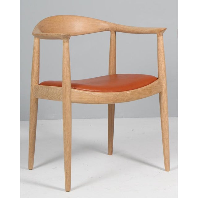 Hans J. Wegner armchair "The Chair" in soap treated oak. New upholstered with tan full grain leather. Model JH-503, made...