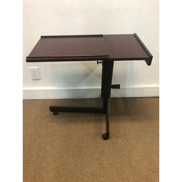 Levenger Danish rosewood rolling table stand. Extends 38 inches the most and is in good condition. This item includes...