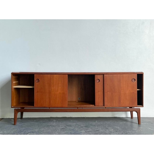 This exceptional Mid-Century Modern credenza is a quintessential example of Danish design by the renowned Arne Hovmand-...