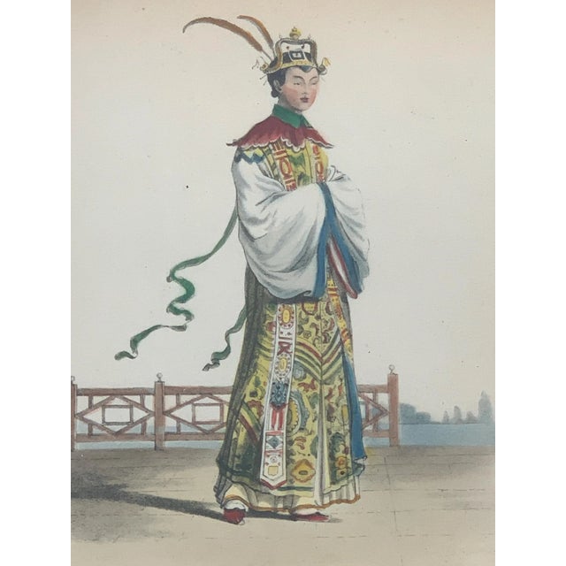 A refined and quietly dramatic 19th-century French hand-colored lithograph depicting a Chinese theatrical performer,...