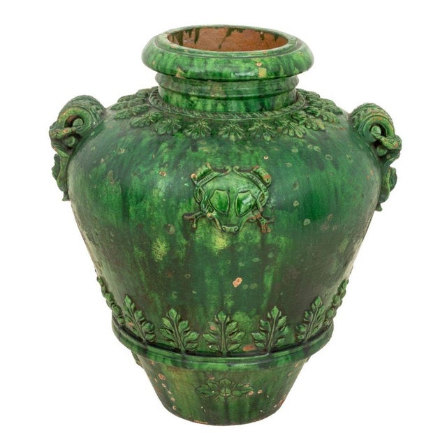 Italian Green Glazed Terracotta Two Handle Vase, 19th century, the baluster vase with applied coat of arms, masque head...