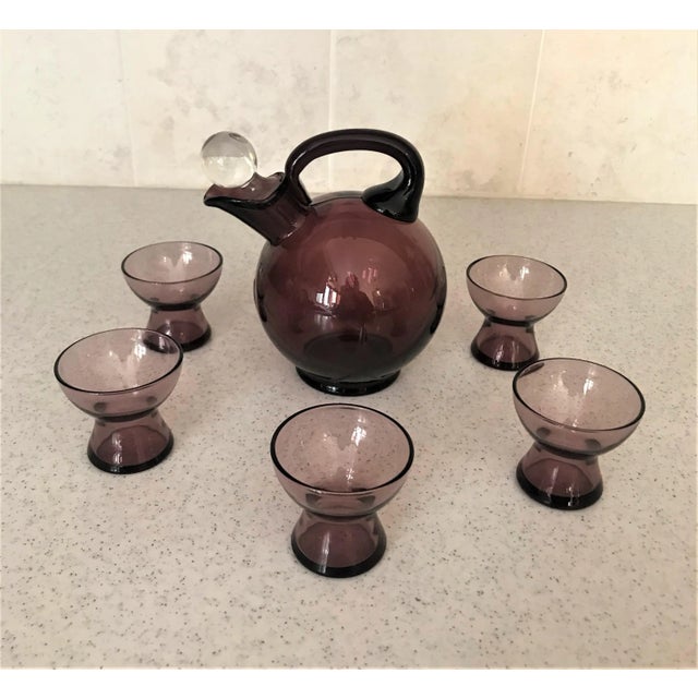 Art Deco amethyst glass decanter set with five cordial/shot glasses. I believe that it may be designed by Cambridge Glass...