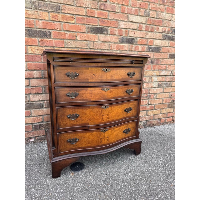 This is Early 20th century serpentine chest of drawers from England and it has a nicely grained top. The is a small chest...