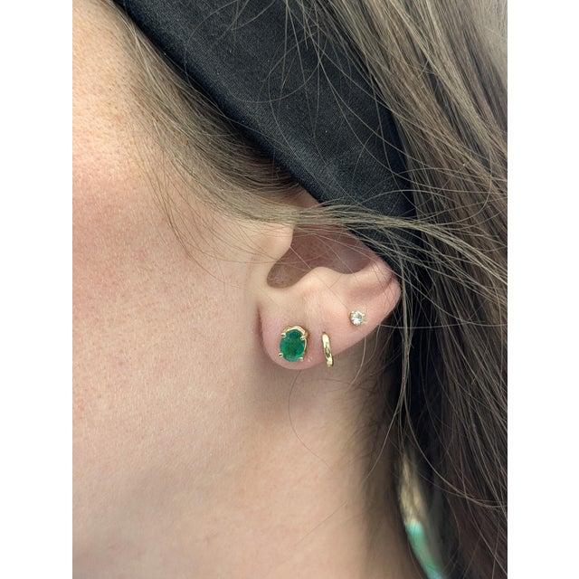 Add a touch of timeless elegance with these 1.4 carat oval-cut emerald solitaire studs. Set in solid 14K yellow gold, each...