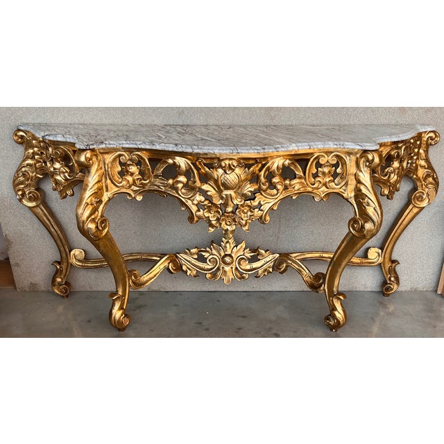 A magnificent and large scale Spanish 20th century Baroque style, ormolu and white marble freestanding console. The most...