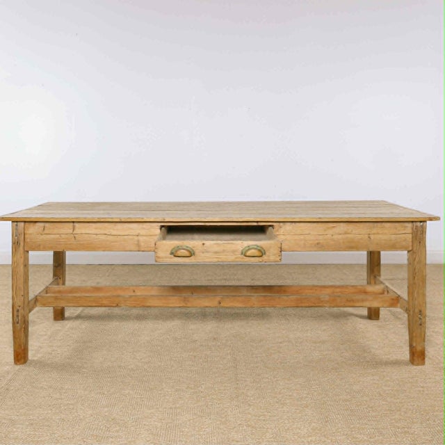 Dimensions: 31"D x 93.5"L x 31.5"H Skirt: 24"H A beautiful antique Irish pine dining table with wonderfully simple...