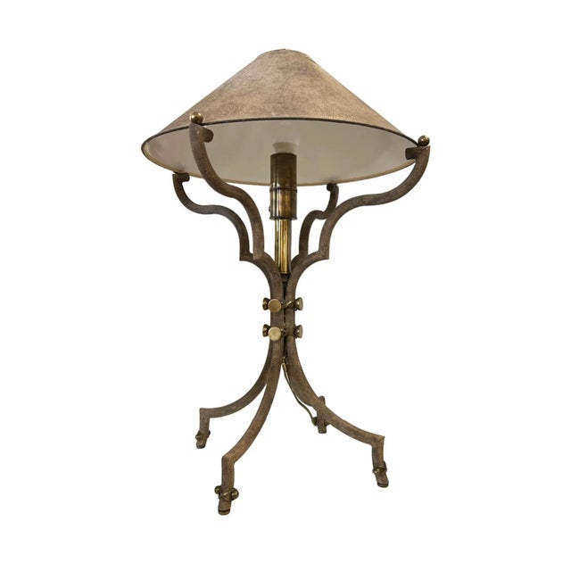 The lamp's base features strong geometric shapes and lines, maintaining a clean and somewhat minimalist aesthetic. The...