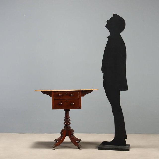19th-century center table crafted in mahogany, featuring a drop-leaf top with sophisticated inlay in rosewood, ebony, and...