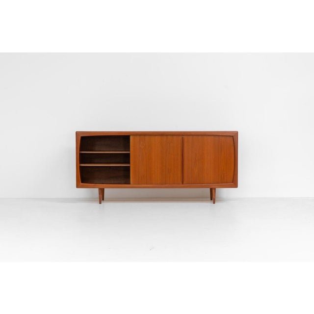 Sideboard in teak Svend Dyrlund (Denmark, 1960s). A beautifully crafted piece showcasing exceptional Danish design and...