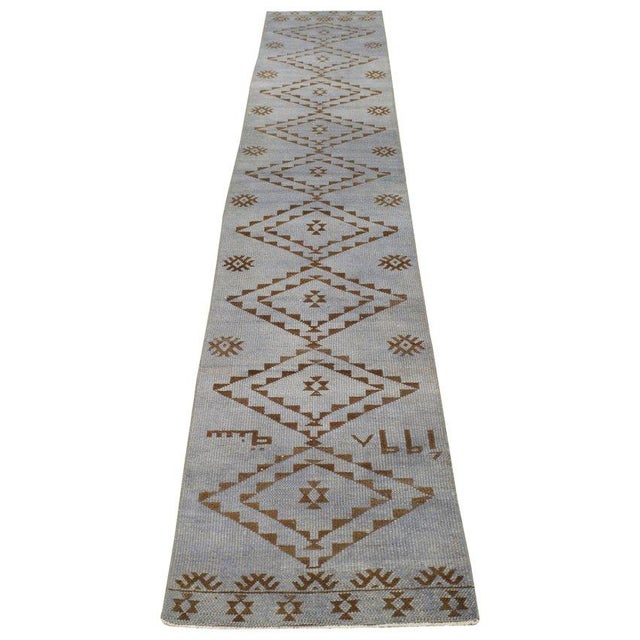 Hand-knotted with care using traditional rug-making techniques, this wool rug blends timeless craftsmanship with a modern...