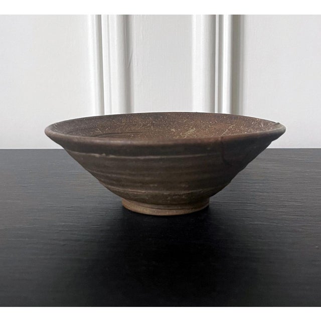A "Kakinoheta" type ceramic chawan (tea bowl) made in Korean during Joseon dynasty circa 16th-17th century. The bowl has a...