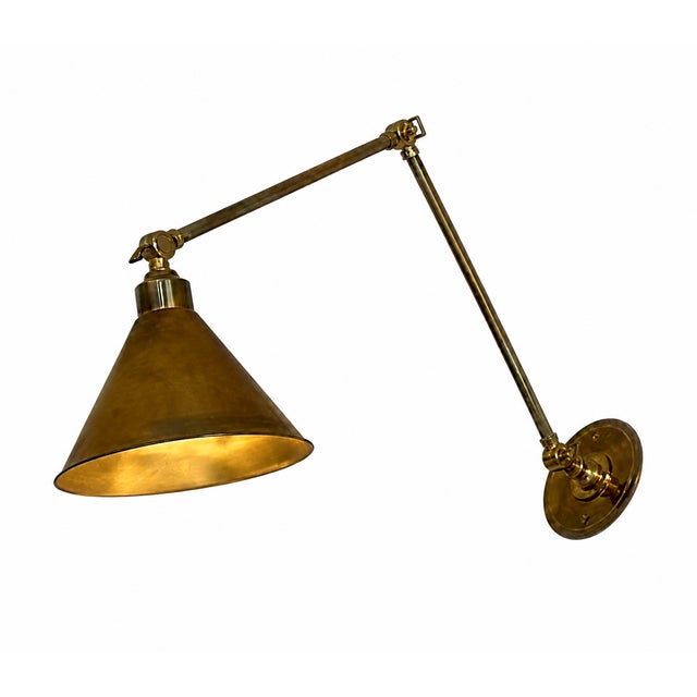 Set of 3 Ann-Morris brass library sconces featuring adjustable swing arms, conical metal shades, and an aged brass finish....
