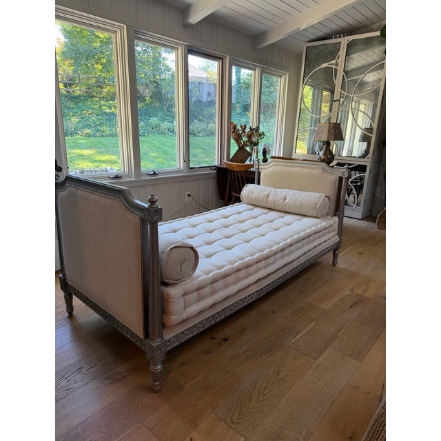 Vintage Oly daybed. Upholstered in their sand colored herringbone fabric with silver leaf frame. Crack on one side of the...