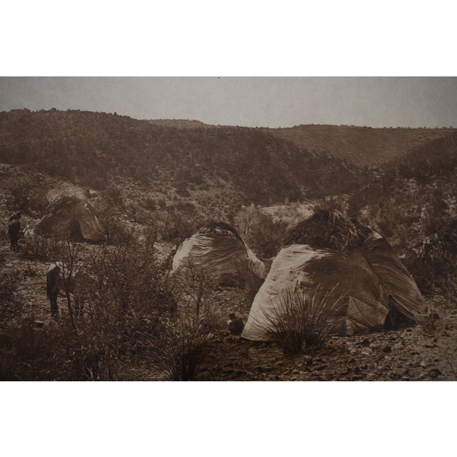 An original vintage photogravure from Edward S. Curtis's landmark The North American Indian. Mescal Camp – Apache is a...