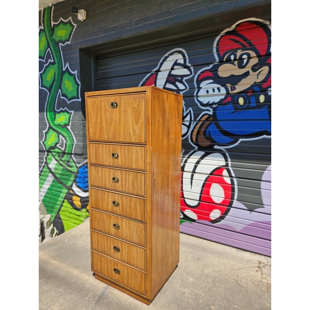 Seven-drawer Drexel campaign tall chest offering high-capacity vertical storage in a compact footprint. Graduated drawers...