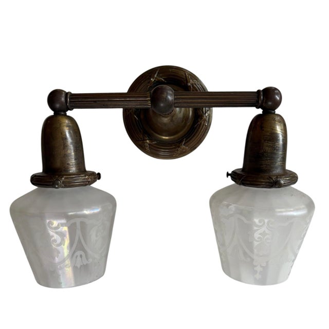 Perfect over a bathroom mirror! This wall sconce has the original stunning iridized acid etched shades Circa 1900. The...