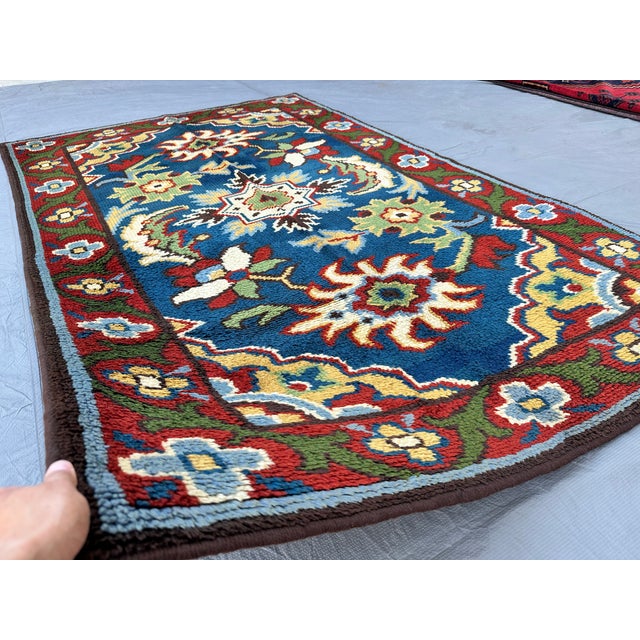 This hand-knotted Chinese Art Deco rug features bold sunburst floral medallions and a central star in cream, green, and...