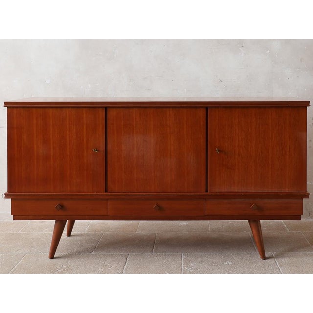 This sideboard is a rare 1960s design by French designer Gaston Poisson. Crafted in teak, it bears the master's signature:...