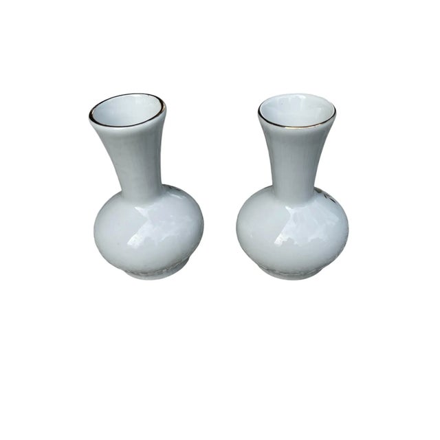 These vintage beautiful bud vases are adorned with red, yellow, and blue flowers. The edge of its opening is trimmed in...