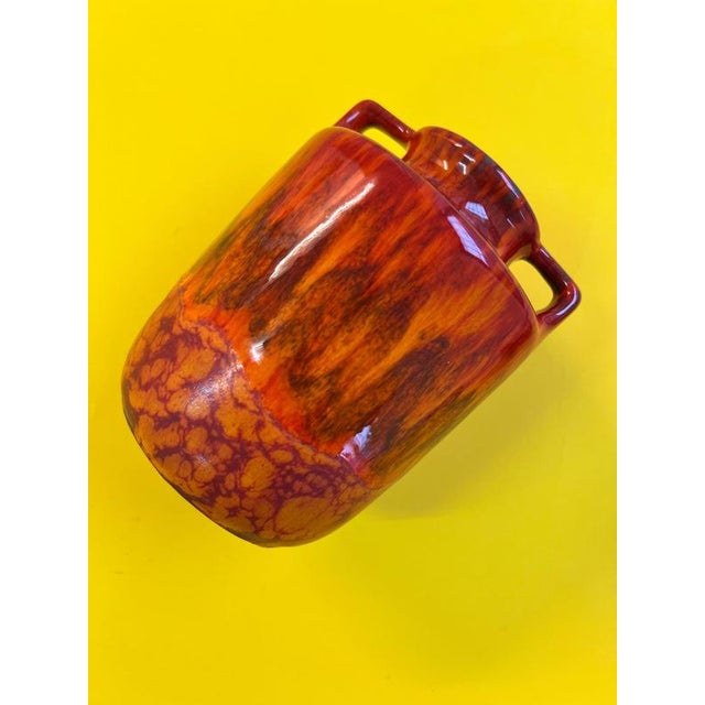 This vase from Scheurich features a striking design with characteristic flame patterns that create a dynamic and...