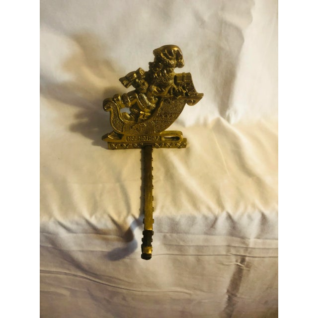 Get ready for the holidays with this brass Santa stocking hanger. Nice weight. Very little patina.
