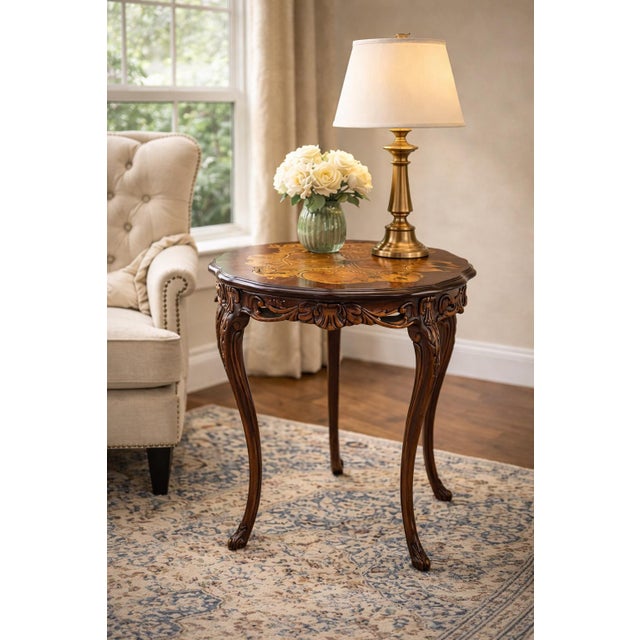 Elegant Louis XV–inspired accent table crafted in richly finished wood with a scalloped edge and intricate floral...