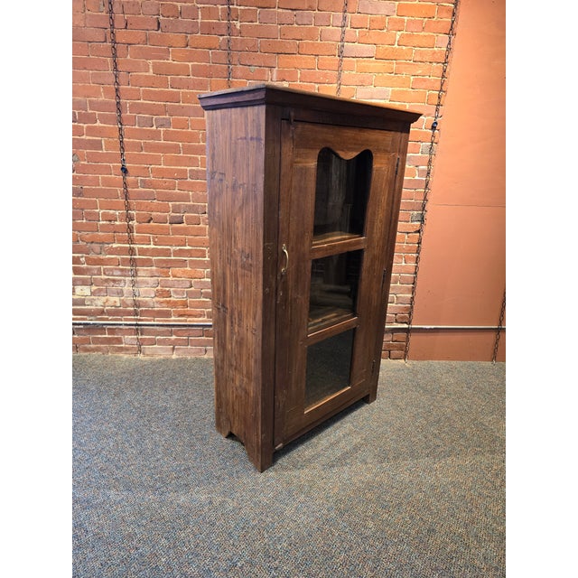Enhance your space with this beautiful, hand-crafted solid wood cabinet. Featuring a rich, dark natural grain and a rustic...