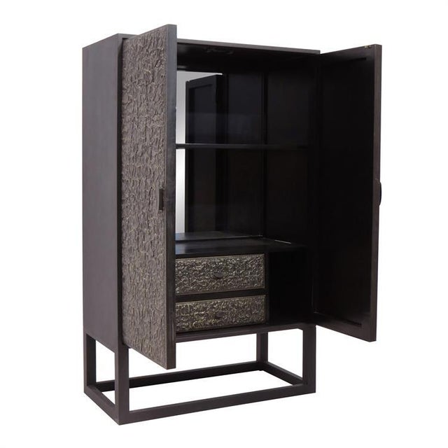 The Glenn Tall Bar Cabinet The texture of the metal cladded doors on the Glenn Tall Bar Cabinet stem from 1950's paper...