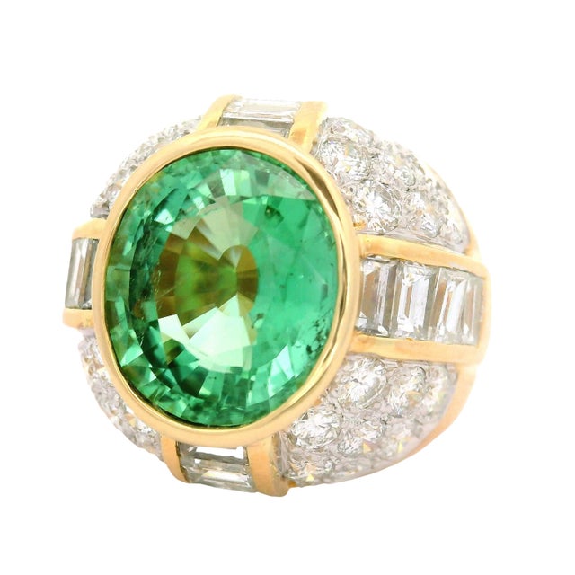 A striking cocktail ring featuring a captivating Paraiba Tourmaline. Weighing 5.99 carats, the stone boasts a vibrant...