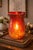 Oversized red-to-amber mosaic glass hurricane candle holder with dramatic glow and warm ombré tones — a bold statement...