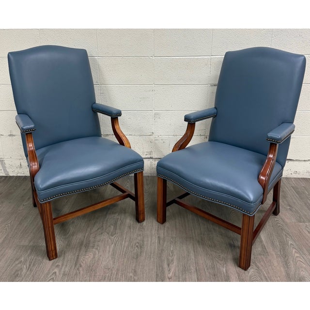 This is a gorgeous pair of vintage Chippendale style blue leather and nailhead executive armchairs or library chairs with...
