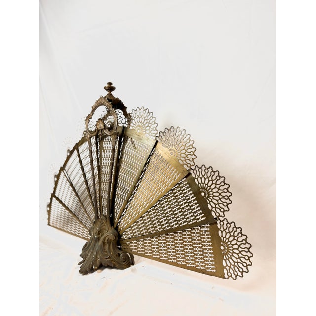 Opulent and intricate brass fireplace peacock fan screen that fans open as seen in photographs. Would give a romantic,...