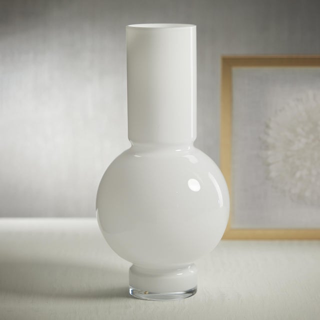 A modern, contemporary glass vase with a slender neck and robust center, suitable for flowers, or being displayed empty....