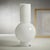 A modern, contemporary glass vase with a slender neck and robust center, suitable for flowers, or being displayed empty....