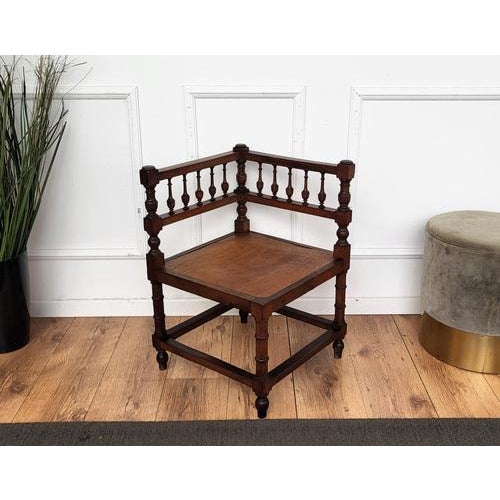 A very charming and besutifully carved and crafted wood corner chair with its aligator shaped seat.