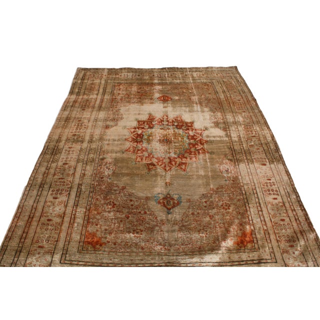 Originating from Persia in 1910, this antique Tabriz Persian rug is hand-knotted with a soft, quality wool pile married to...