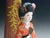 This Mid 20th century (1953-55) piece of folk art or mingei Hakata sculpture is a low fired ceramic bisque finish doll of...
