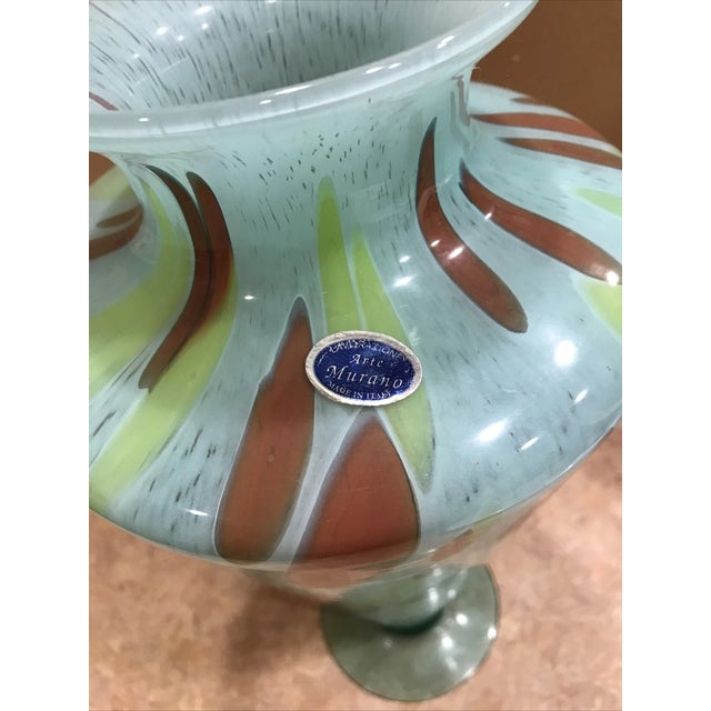 Striking vintage Italian art glass vase labeled “Lavorazione Arte – Made in Italy,” featuring a bold blend of blue, green,...