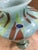 Striking vintage Italian art glass vase labeled “Lavorazione Arte – Made in Italy,” featuring a bold blend of blue, green,...
