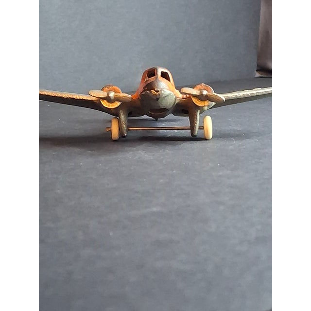 This is a highly collectible, authentic 1930s cast iron toy airplane manufactured by the renowned Hubley Manufacturing...